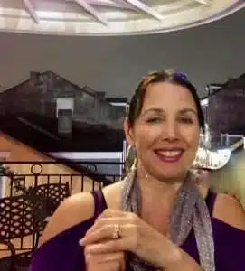 A woman with brown hair and a friendly smile.