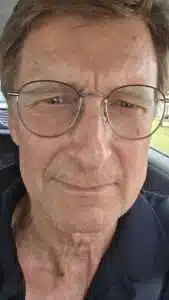 A closeup photo of a man in glasses.