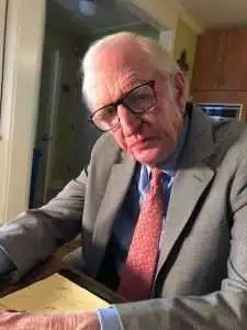 A man in a suit and glasses.