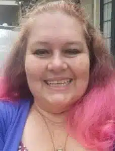 A woman smiling at the camera.