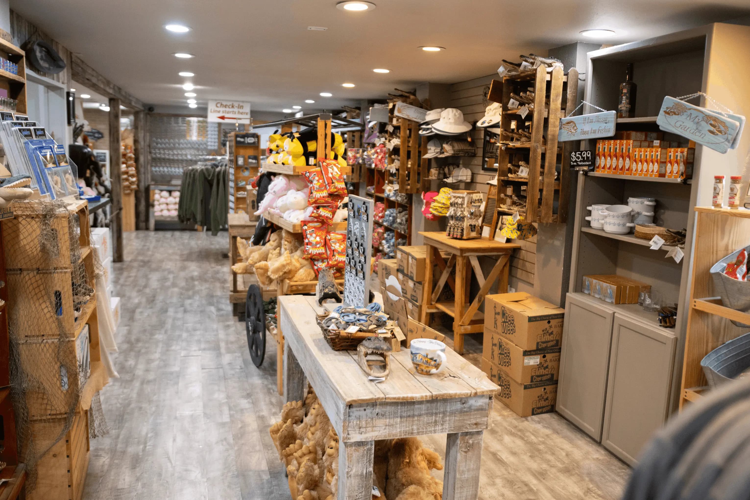 A wide-set photo of Cajun Encounter's Gift Shop, featuring a table with swamp-themed knick-knacks