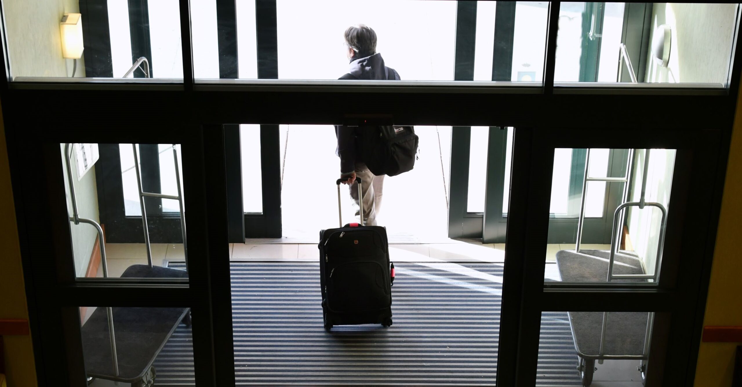 a guest walks out of the entrance of a hotel in New Orleans